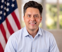 Official headshot preview: Justin DePascale in front of an American flag